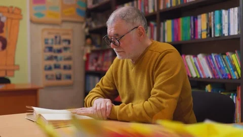 The Book Oasis A Senior Man Finding Solace in Reading Stock Footage 274288319