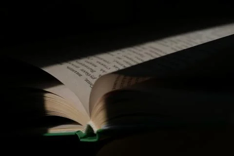 Book open on a black background Stock Photos