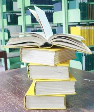 Book open on books stack Stock Photos