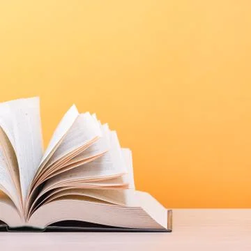 The book is open, lying on the table, the sheets spread out like a fan on a y Stock Photos