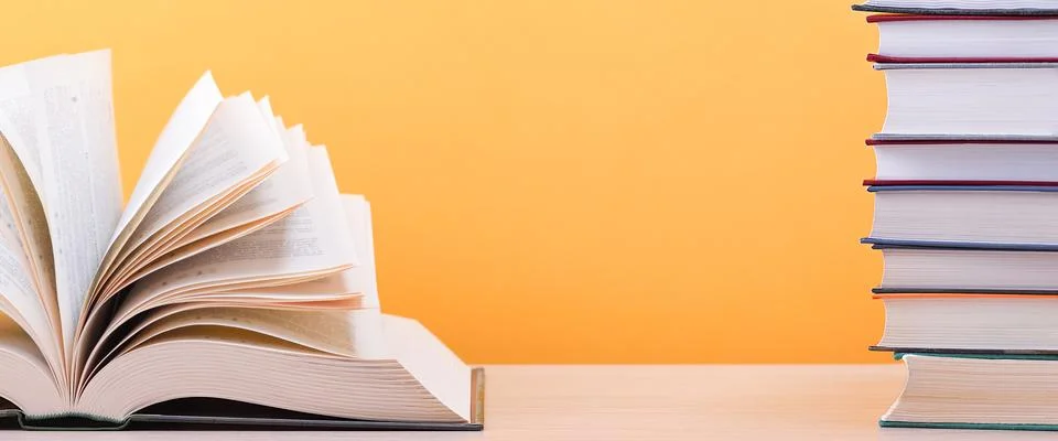 The book is open, lying on the table, the sheets spread out like a fan on a y Stock Photos