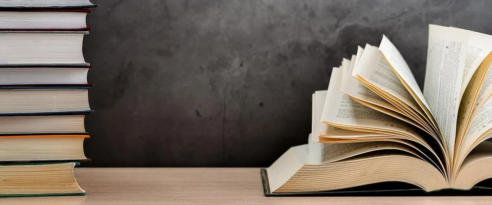The book is open, lying on the table, the sheets spread out like a fan on a b Stock Photos