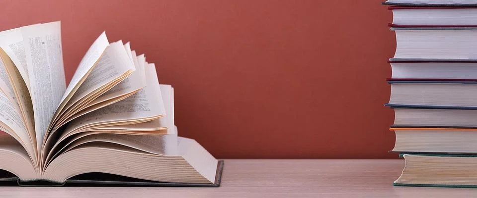 The book is open, lying on the table, the sheets spread out like a fan on a b Stock Photos