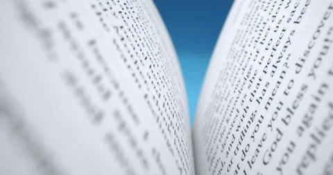 The book is open for reading. A man opens a book to read, on a blue background Stock Footage 157639652