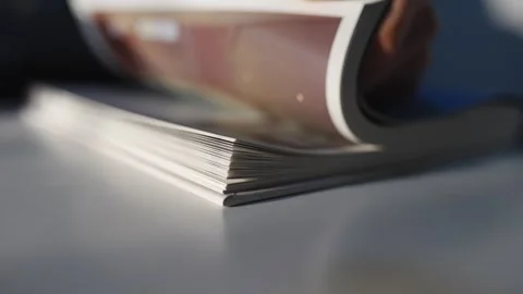 A book is opened to a page with a person's hand on it Stock Footage 302442424