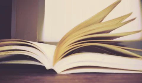 A book is opening on desk Stock Photos