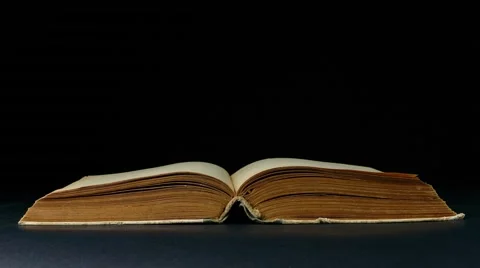 Book page turning on black background 4k footage Stock Footage 53935347