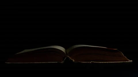 Book page turning on black background 4k footage Stock Footage 53936157
