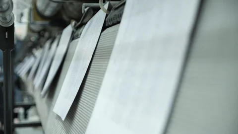 Book pages fall in slow motion on the tape and move along a conveyor belt. Stock-Footage 98115583