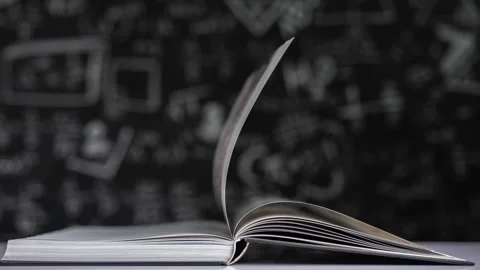 Book pages flipping in stop motion on a blackboard background Stock Footage 160540398