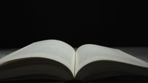 Book Pages Turning in Slow Motion Against Black Background Stock Footage 330408995