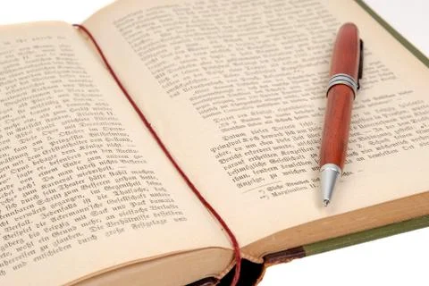 Book with a pen Stock Photos