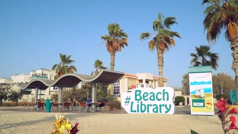 Book reading in beach library at kite beach Dubai United Arab Emirates Stock Footage 189140219