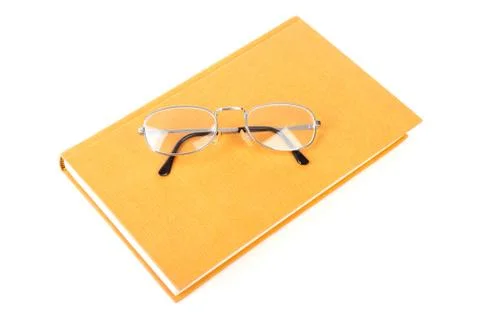 Book with reading glasses Stock Photos