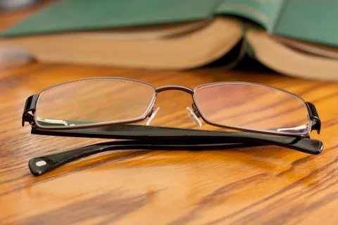Book with reading glasses Stock Photos