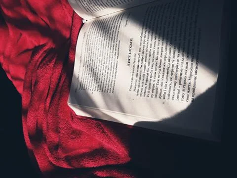 Book on red blanket Stock Photos