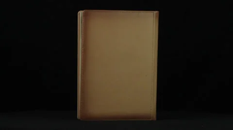 Book revolves on a black background loop Stock Footage 34660718