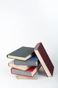 Book stack, hardback colorful books on wooden table, white background. Back.. 스톡 사진
