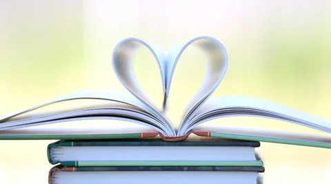 Book stack open page heart shape in wind. Stock Footage 38002697