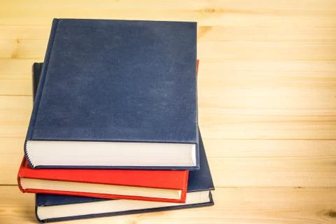 Book stack on wood desk Stock Photos