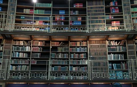 Book stack on wooden shelves inside The Reading Room situated in the centre.. Stock Photos