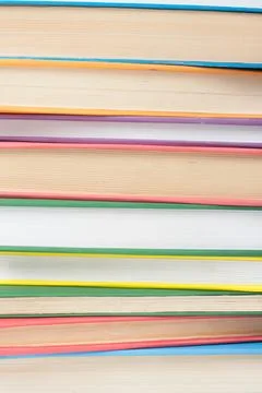 Book stacking. Open book, hardback books on wooden table and blue background. Stock-Fotos