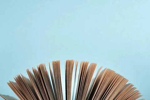 Book stacking. Open book, hardback books on wooden table and blue backgroun.. Stock Photos