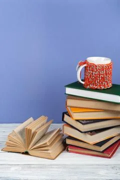 Book stacking. Open book, hardback books on wooden table and blue backgroun.. Stock Photos