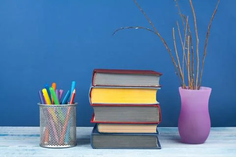 Book stacking. Open book, hardback books on wooden table and blue backgroun.. Stock Photos