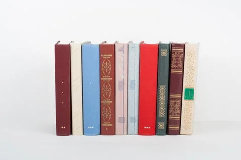 Book stacking. Open book, hardback books on wooden table and white background Stock Photos