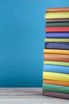 Book stacking. Open hardback books on wooden table and blue background. Bac.. Stock Photos