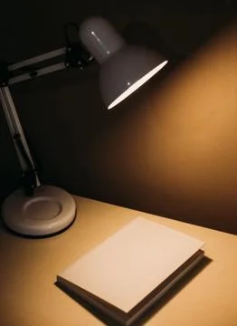 Book table dark office table lamp yellow Foto stock