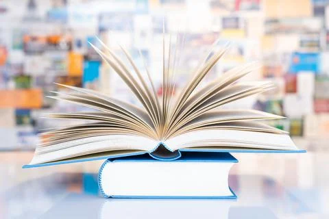 Book on table in front of colorful soft background Stock Photos