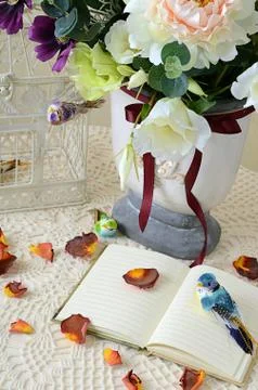 The book on a table with rose petals Stock Photos