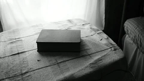 Book on a table by the window Stock Footage 133027855