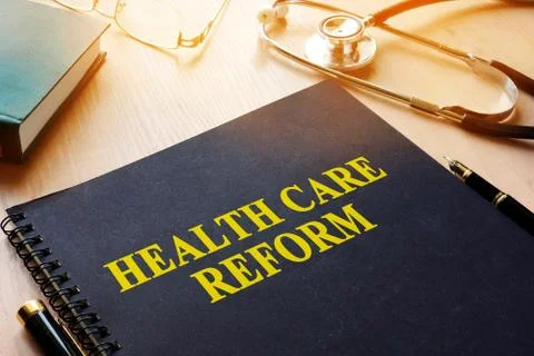 Book with title health care reform on a desk. Stock Photos