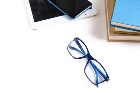 Book vs. e-book. Eyeglasses, books and e-books isolated on white background. Stock Photos