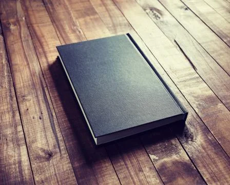 Book on wood table Stock Photos