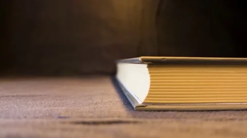 Book with yellow lights on a black background Stock Footage 197458006
