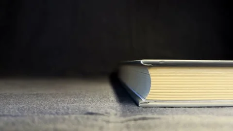 Book with yellow lights on a black background Stock Footage 197458020