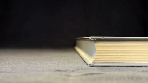 Book with yellow lights on a black background Stock Footage 197458036