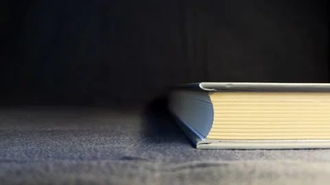Book with yellow lights on a black background Stock Footage 197458050