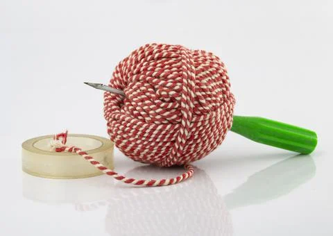 Bookbinding or paper sewing tools on white background. A bundle of rope and a Stock Photos