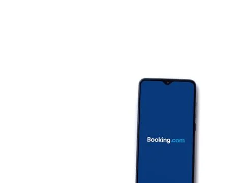 Booking.com app launch screen with logo on the display of a black mobile smar Stock Photos