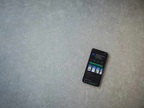 Booking.com app play store page on the display of a black mobile smartphone o Stock Photos
