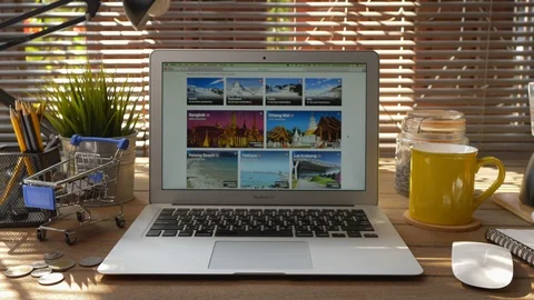 Booking.com hotels search page on the Apple MacBook Air, MacBook Air with app Bo Stock Footage 124010746