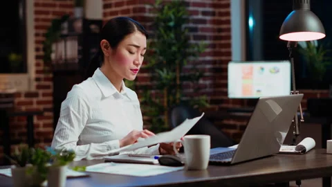 Bookkeeper working in office overnight, bored of checking financial data graphs Stock Footage 263263056