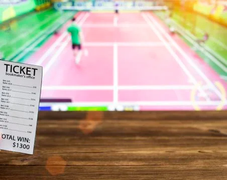 Bookmaker ticket on the background of TV on which goes badminton, betting office Foto stock