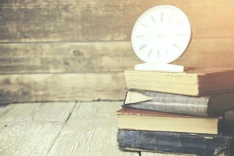 Books and clock Stock Photos