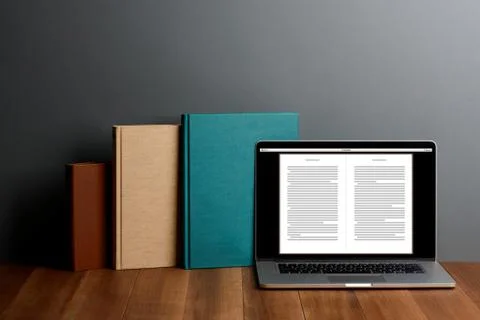 Books and laptop with E-reader app on desktop Stock Photos
